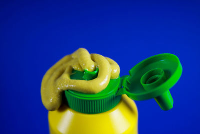 Close-up of green toy over blue background