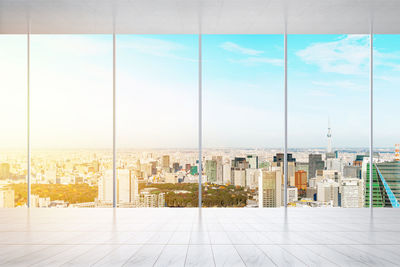 Cityscape seen through glass window during sunset