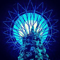 Low angle view of ferris wheel against sky at night