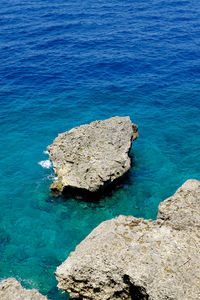 High angle view of rock formation in sea