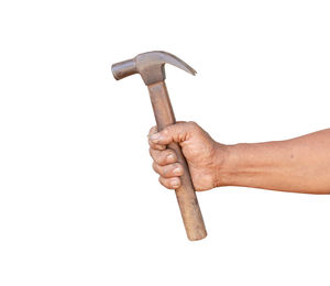 Close-up of hand holding cross against white background