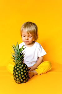 Close-up of pineapple against yellow background