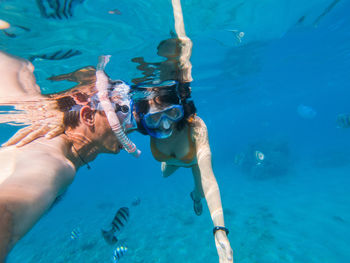 Couple snorkeling in sea