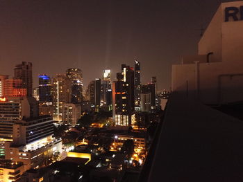 High angle view of illuminated buildings against sky at night