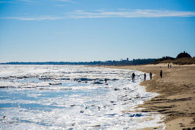 Scenic view of beach against blue sky