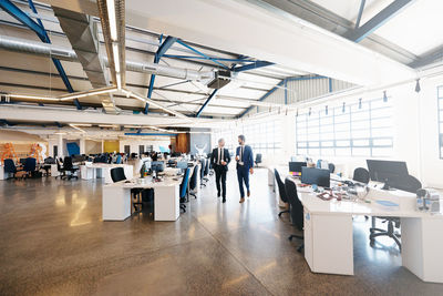 Businessmen walking in office