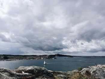 Scenic view of sea against cloudy sky
