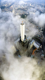 Aerial view of buildings in city during foggy weather