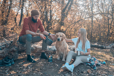 People sitting with dog in background