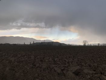 Scenic view of field against sky during sunset