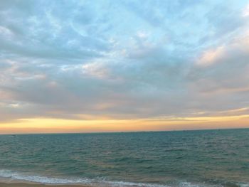 Scenic view of sea against cloudy sky