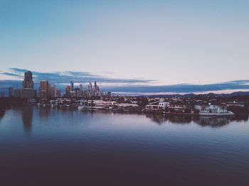 Scenic view of sea and buildings against clear sky