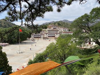 High angle view of buildings and trees against sky