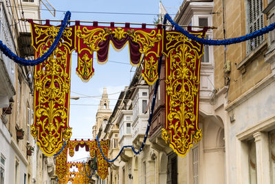 Low angle view of decoration amidst residential buildings