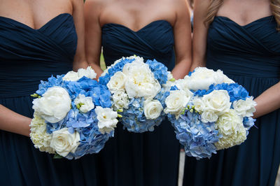 Midsection of woman holding bouquet