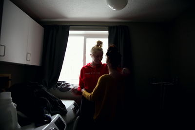 Young woman sitting in corridor