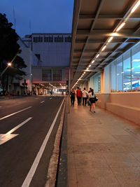 People walking on footpath in city