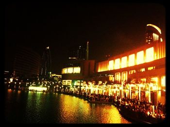 VIEW OF ILLUMINATED BUILT STRUCTURES AT NIGHT
