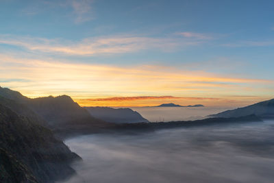 Scenic view of mountains against sky during sunset