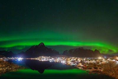 Scenic view of illuminated mountains against sky at night