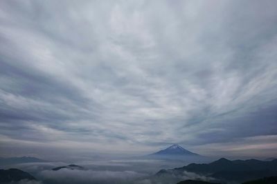 Scenic view of mountains against cloudy sky