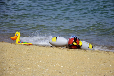 Children's inflatable toys for teaching children to swim. colorful swimming equipment on seashore
