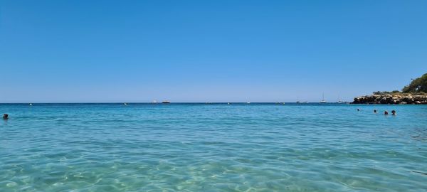 Scenic view of sea against clear blue sky