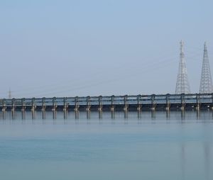 Bridge over river against clear blue sky