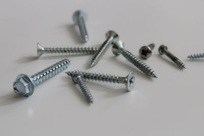 Close-up of screws on white background