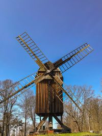 Low angle view of traditional windmill against clear sky