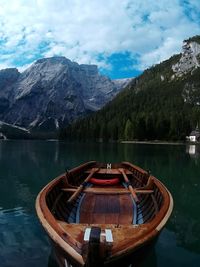 Boat on river against mountain