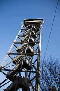Low angle view of metallic structure against clear blue sky