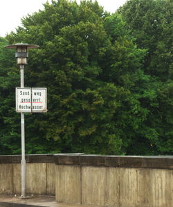 Road sign by trees