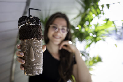 Portrait of young woman holding umbrella
