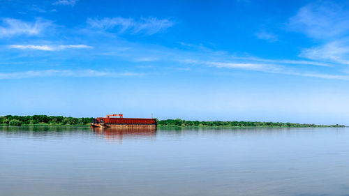 Scenic view of lake against blue sky