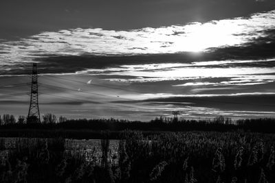 Scenic view of field against sky at sunset