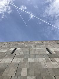 Low angle view of vapor trail against blue sky