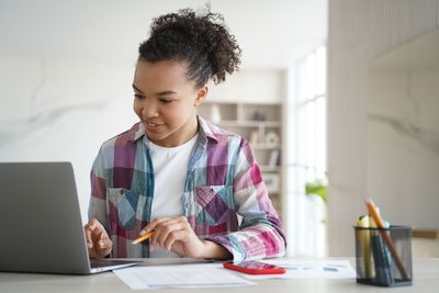 Young woman using laptop at home