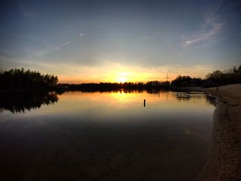 Scenic view of lake against sky during sunset