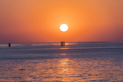 Scenic view of sea against orange sky