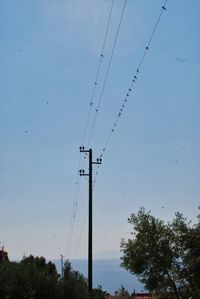Low angle view of electricity pylon against sky