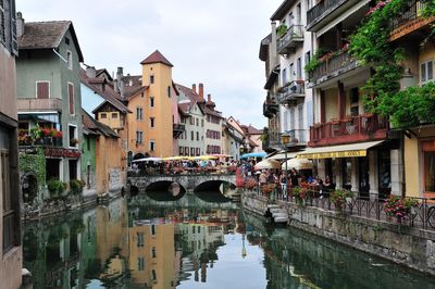 Bridge over canal amidst buildings in city