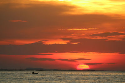 Scenic view of sea against orange sky