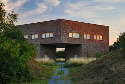 Road amidst buildings against sky in nature