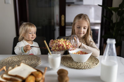 Portrait of smiling boy eating food at home