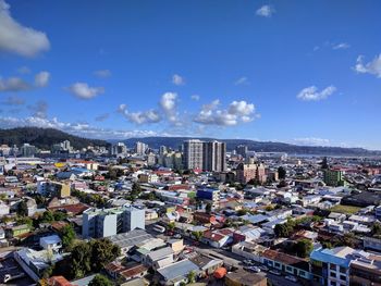 High angle view of townscape against blue sky