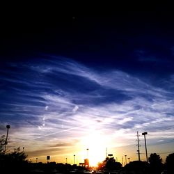 Low angle view of silhouette trees against sky at sunset