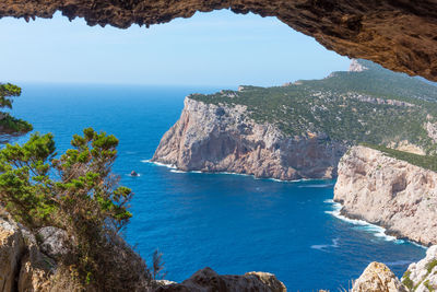 High angle view of rocks on sea shore against sky