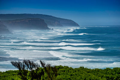 Scenic view of sea against blue sky