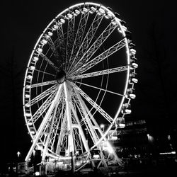 Low angle view of ferris wheel against sky at night